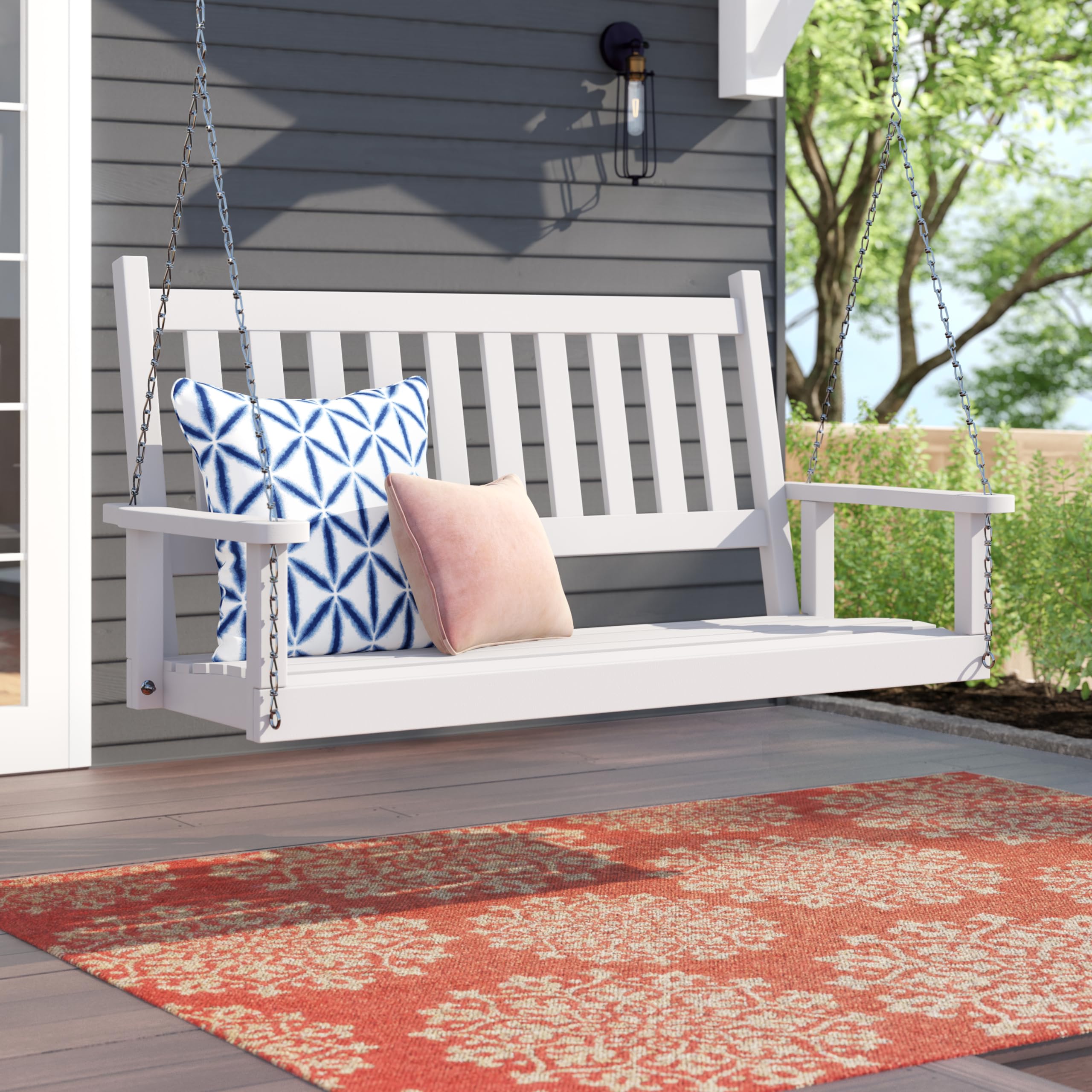 Shine Company swing installed on a porch with pillows showing outdoor living styling
