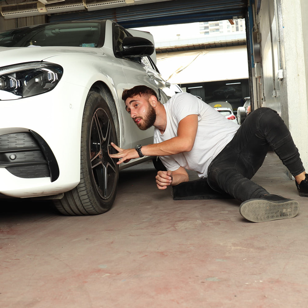SHINY-V kneeling pad on garage floor aiding mechanics during repairs