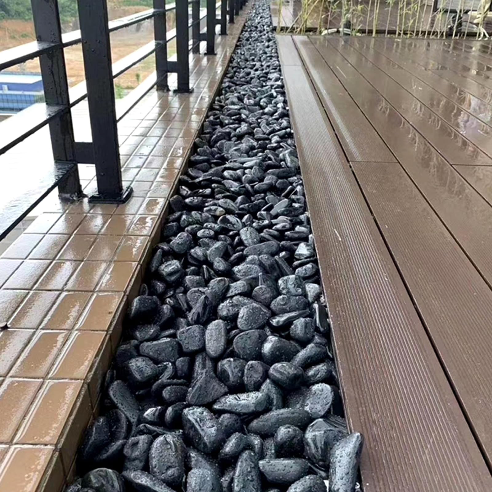 SHIZWU pathway edged with black pebbles showing tidy low-maintenance landscaping