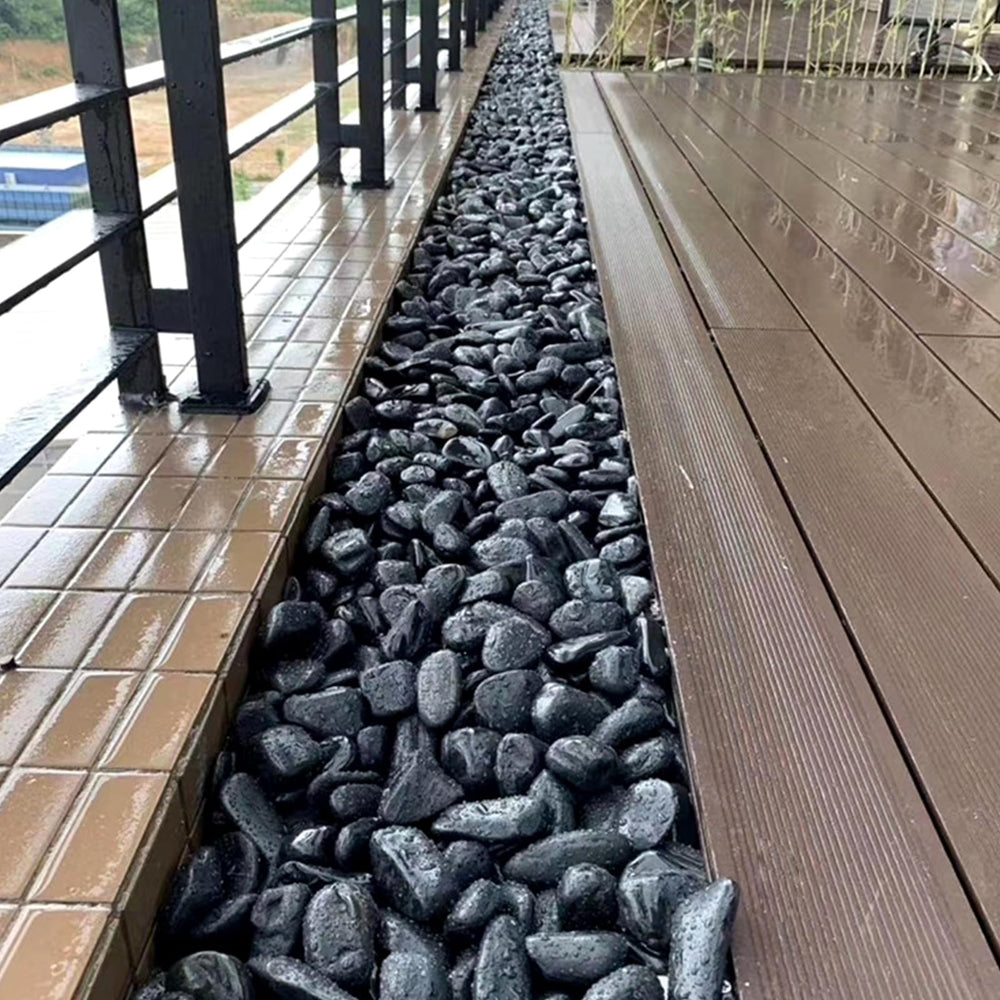 SHIZWU pathway edged with black pebbles showing tidy low-maintenance landscaping
