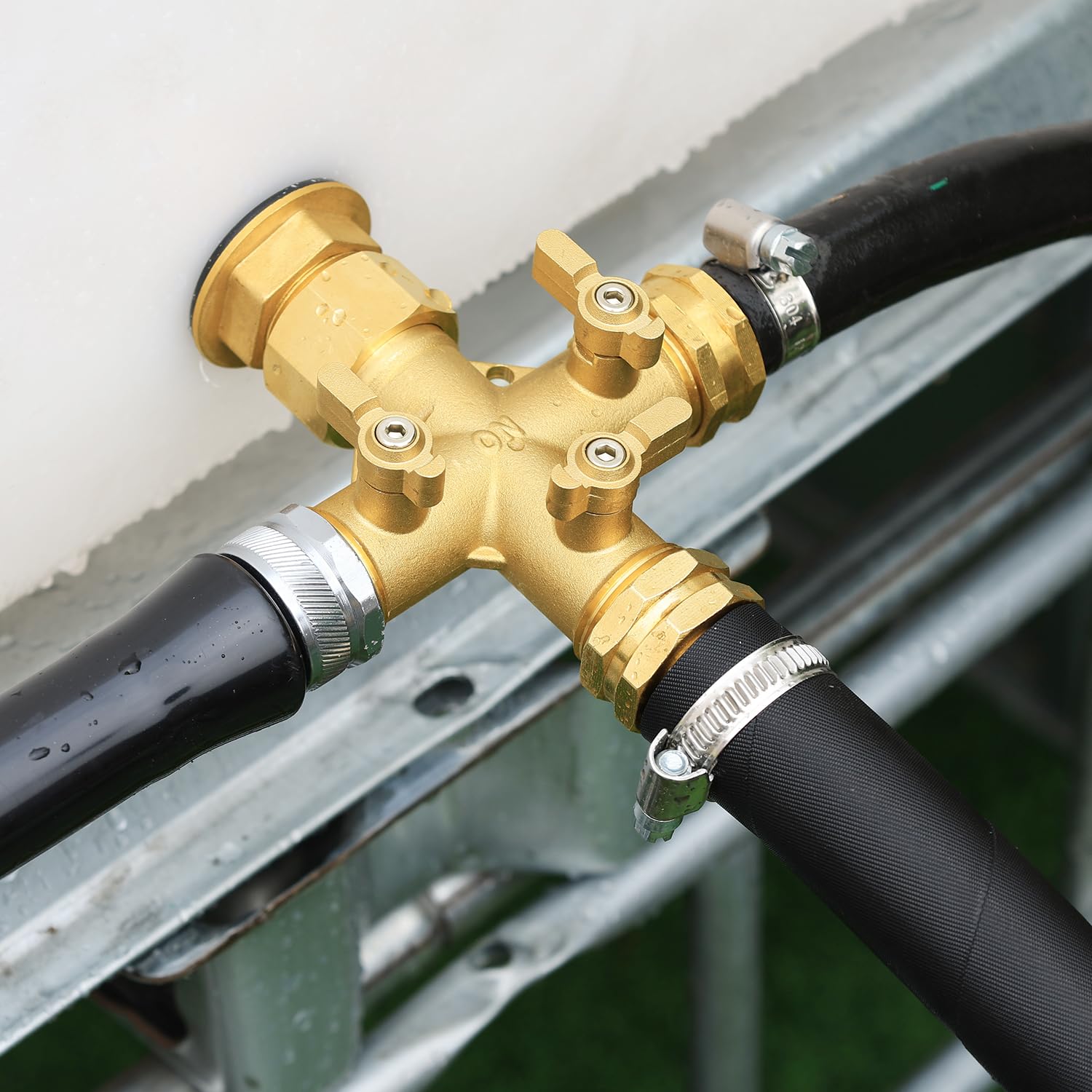 SIGURANTA next to a standard garden hose for scale, illustrating compact size and robust build