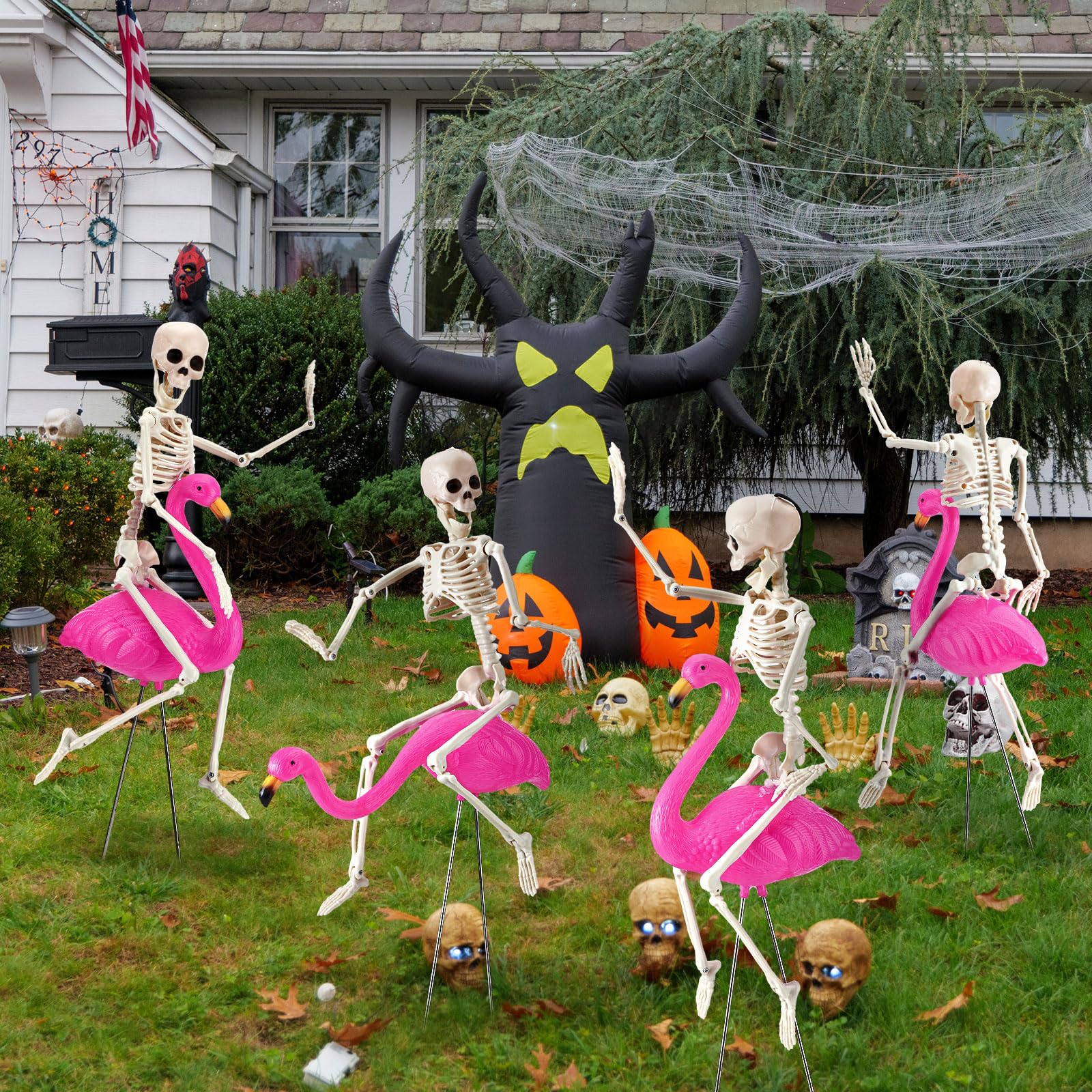 Simgoing yard display with flamingos and skeletons creating playful spooky atmosphere for visitors