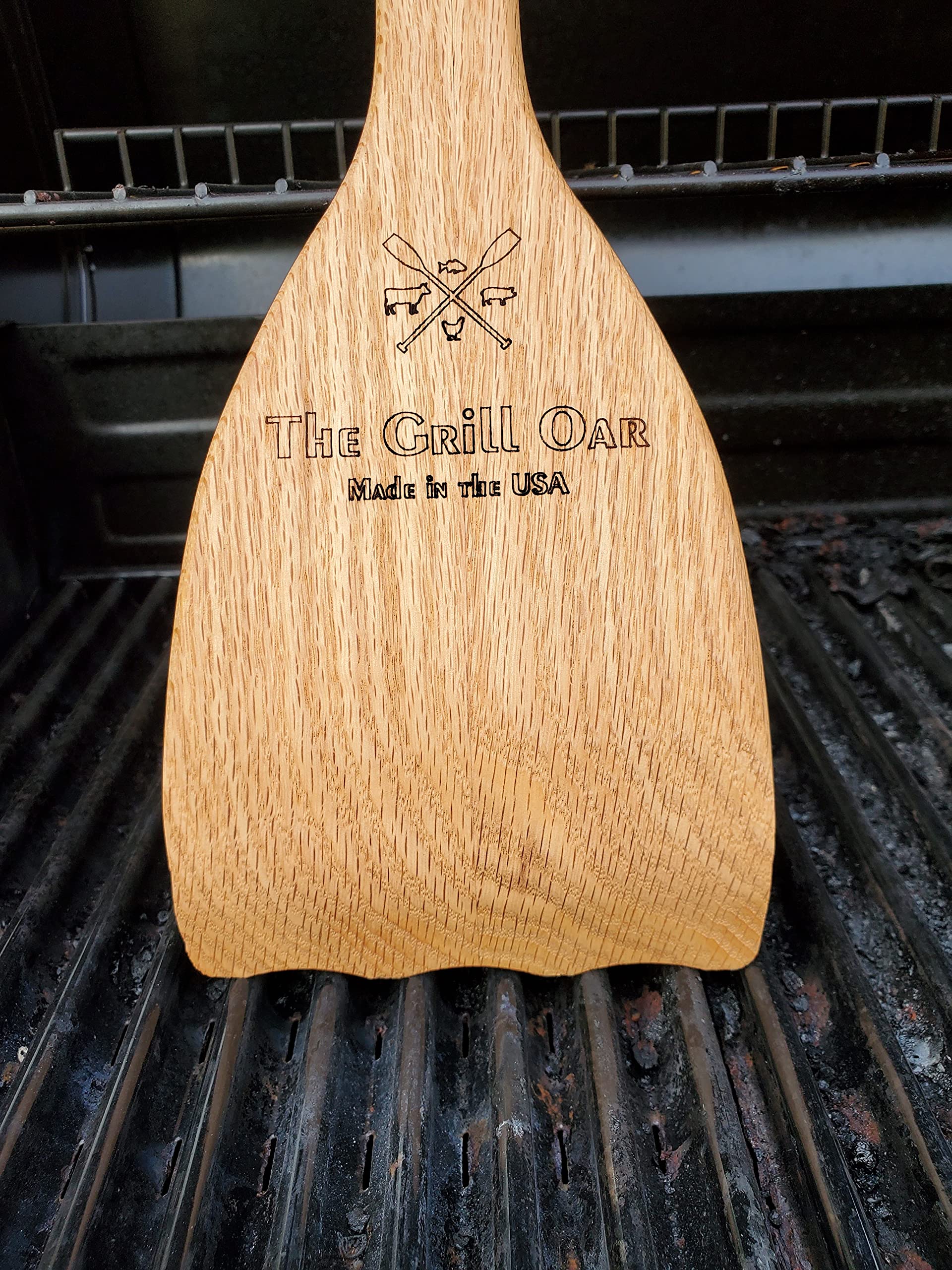 Simply Better Grill Oar removing residue between grates on a hot grill, thorough cleaning