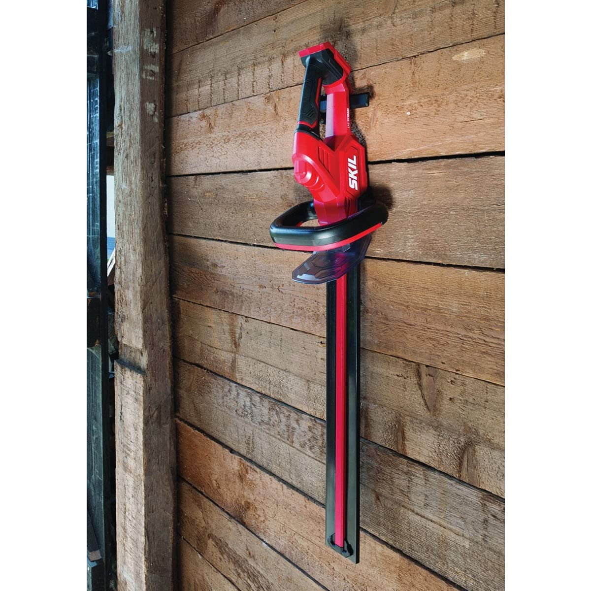 Skil PWR CORE 20 in use trimming hedge showing cordless freedom and reach