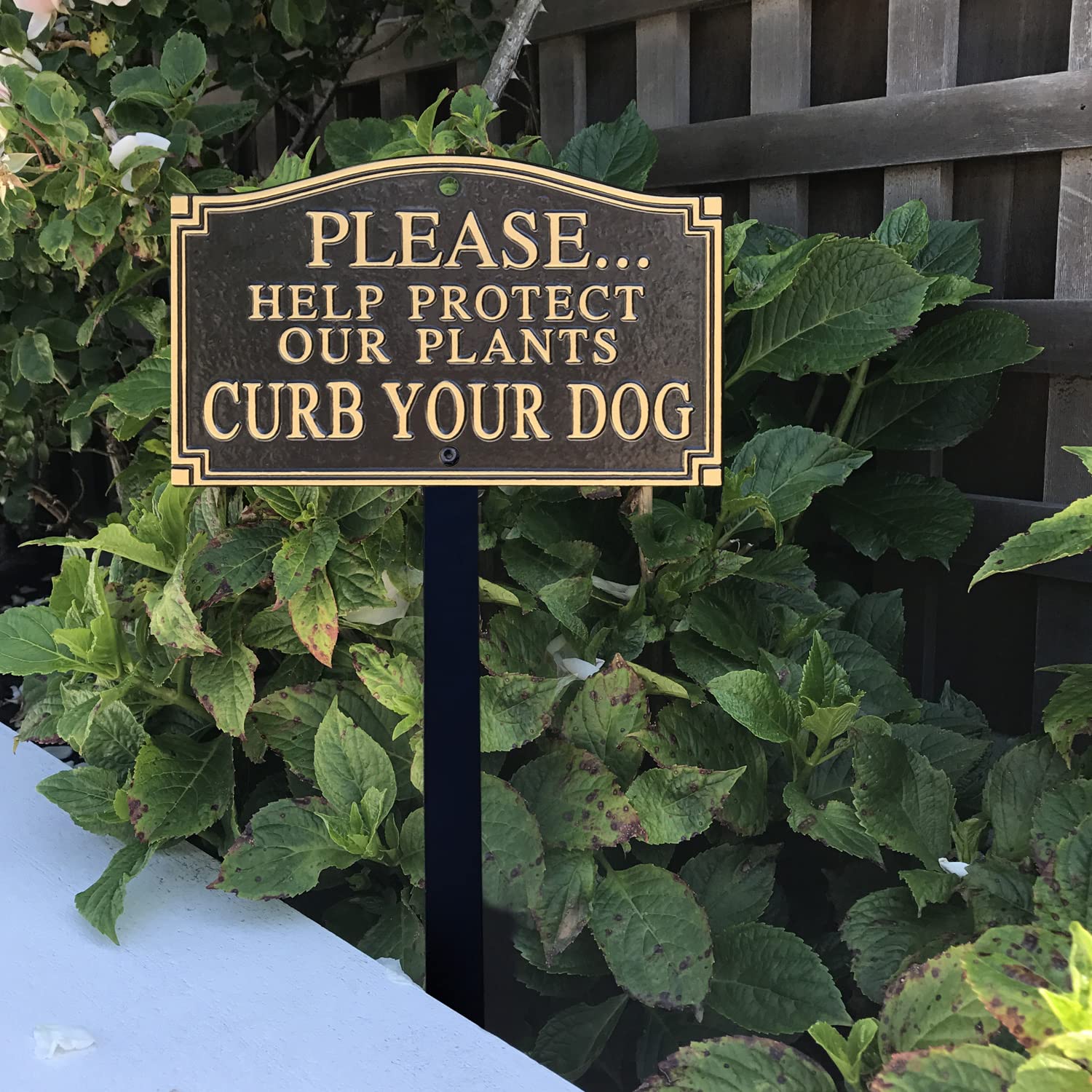 SmartSign plaque mounted on a fence using predrilled holes and included hardware for easy installation