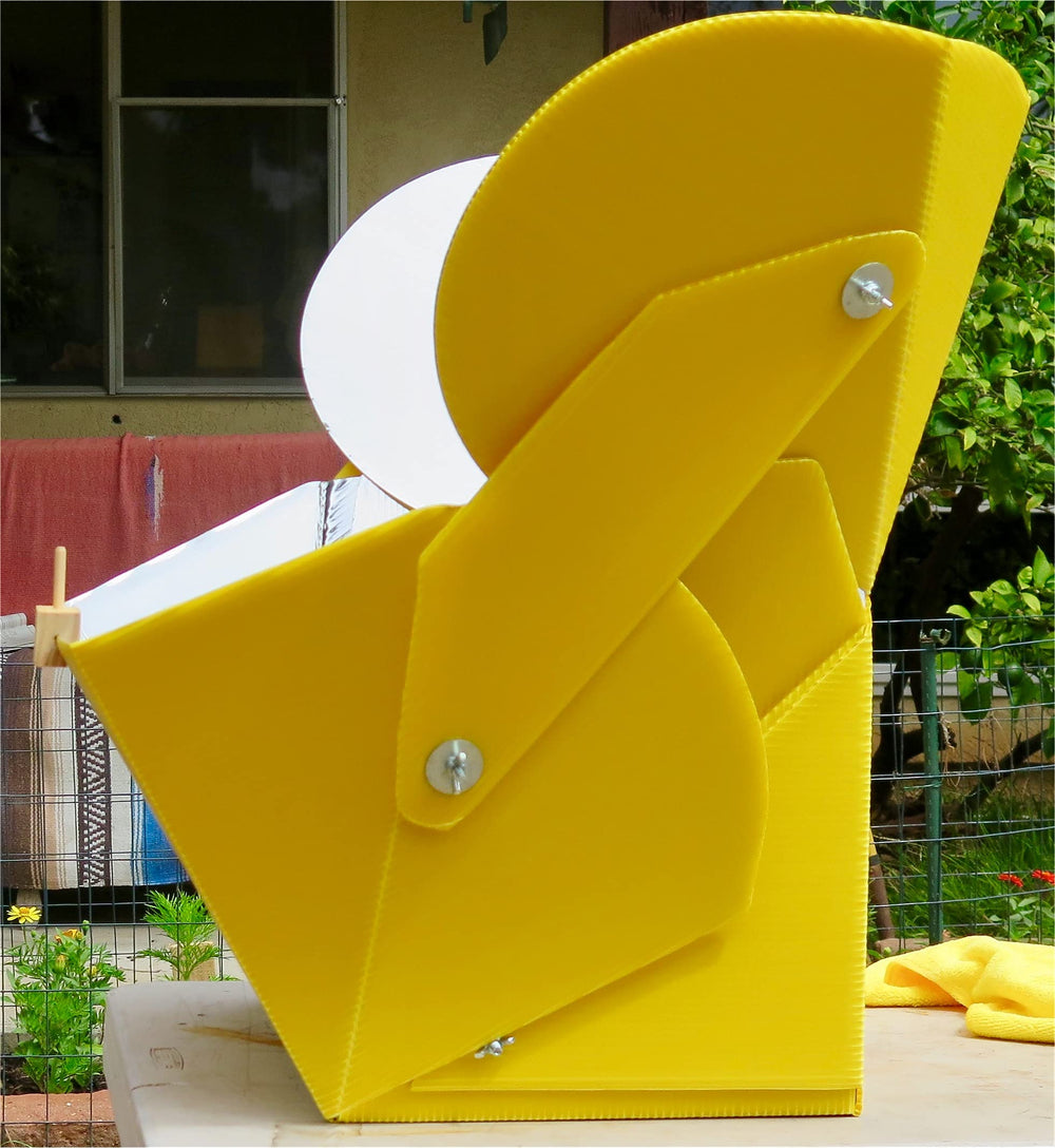 SOL COOK next to backpack showing compact folded size for camping portability