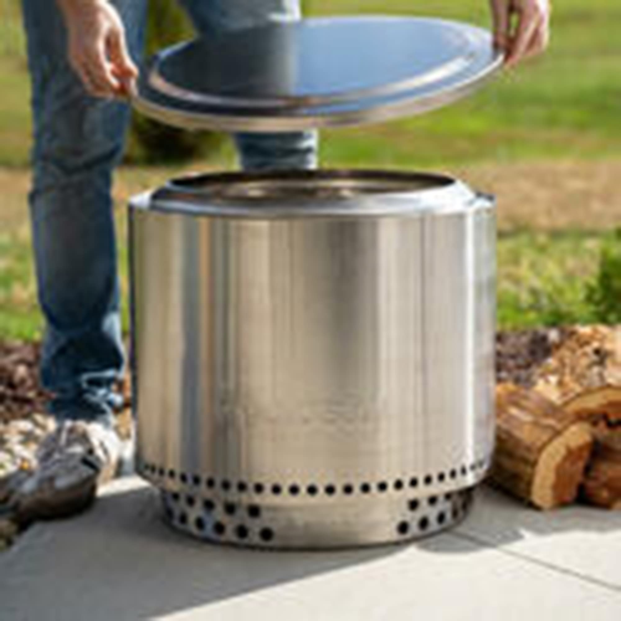 Solo Stove Bonfire lid beside a glass to show scale and stable surface for outdoor gatherings