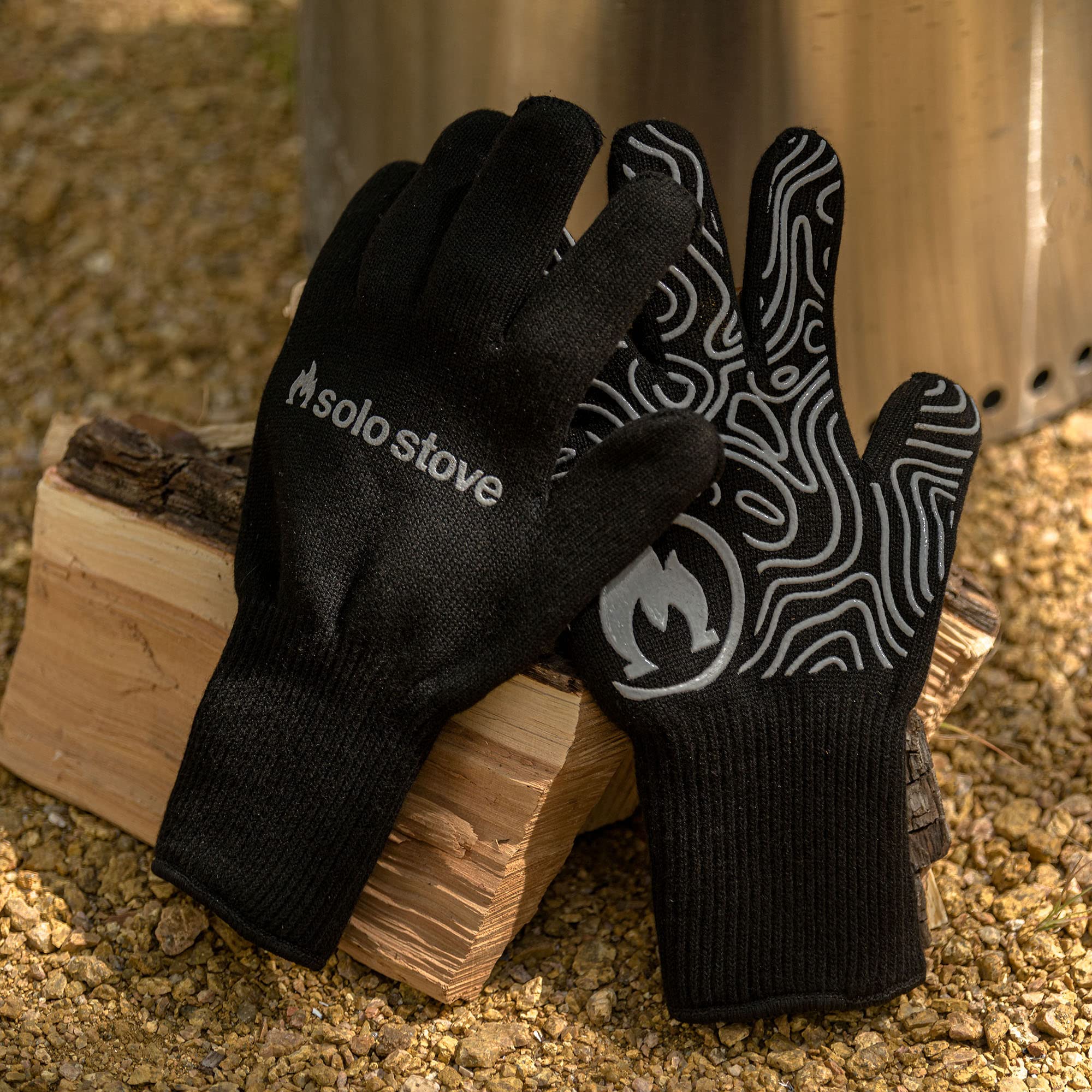 Solo Stove gloves beside fire pit illustrating outdoor protection