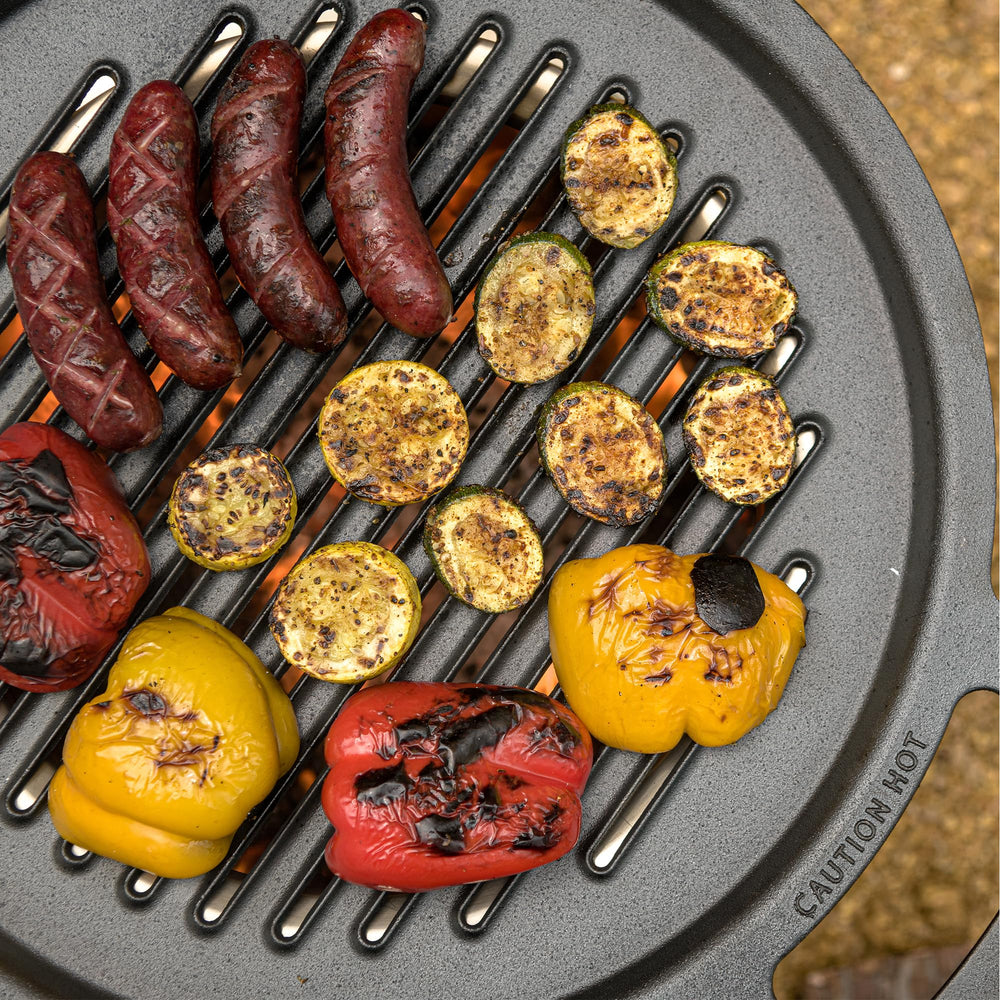 Solo Stove grill in use searing steak over embers showing flavor development benefit