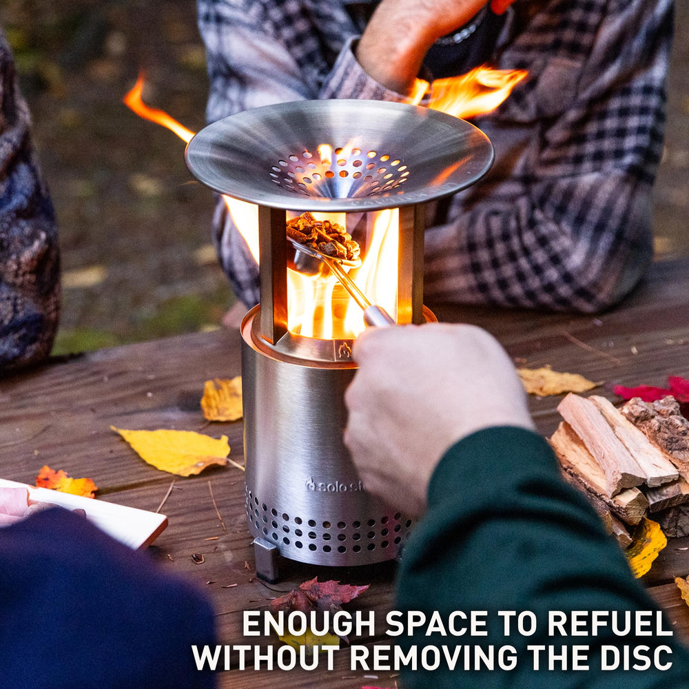 Solo Stove heat deflector mounted on Mesa with people nearby, spreads warmth outward