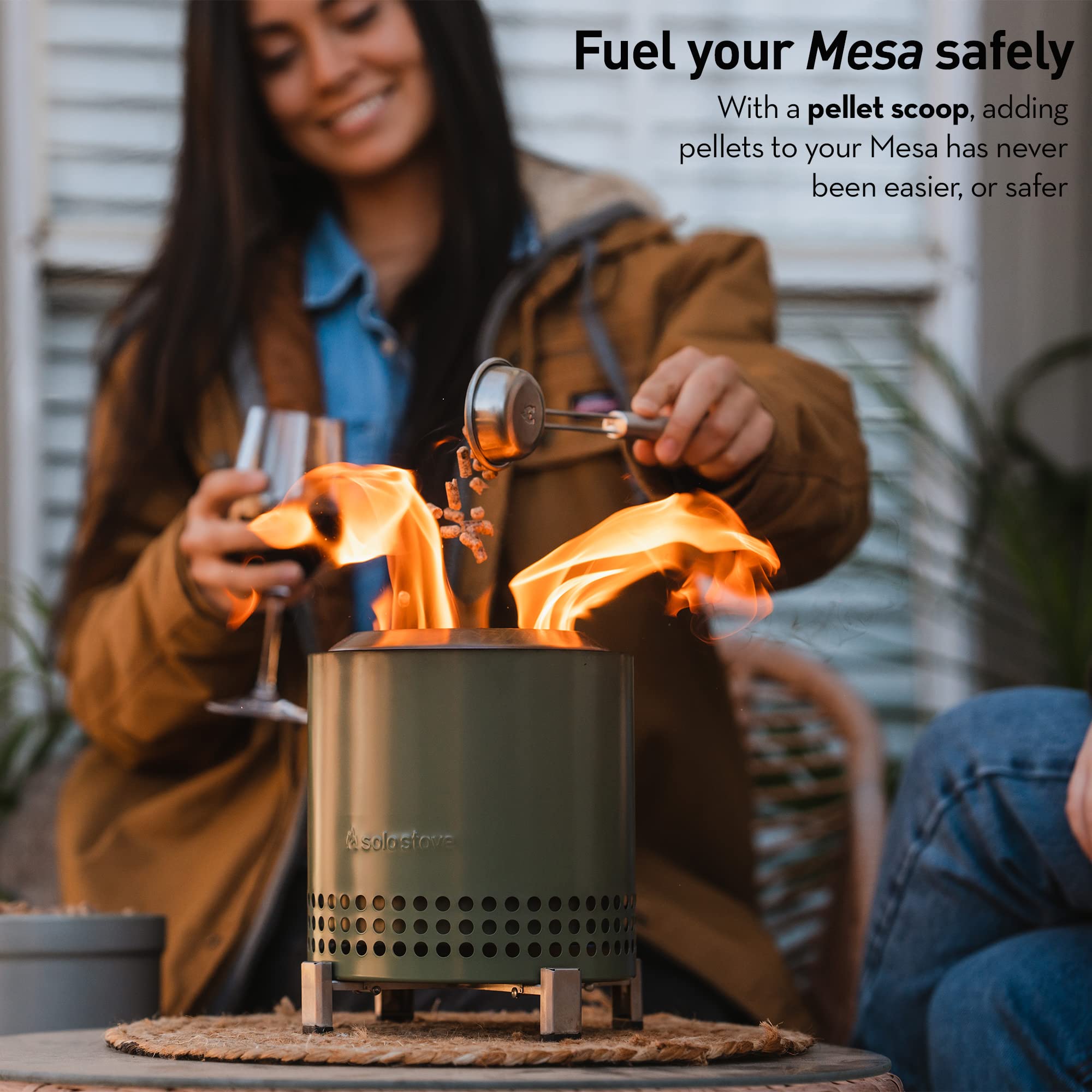 Solo Stove pellet scoop held above Mesa for safe, precise pellet placement and reduced spillage