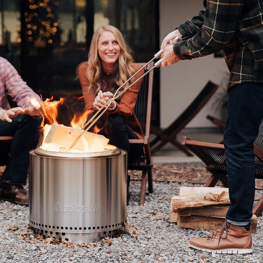 Solo Stove tools displayed beside a fire pit illustrating length and scale for safety