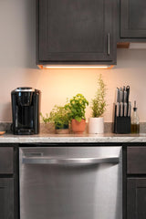 Soltech Grove installed under cabinet illuminating herbs and improving visibility