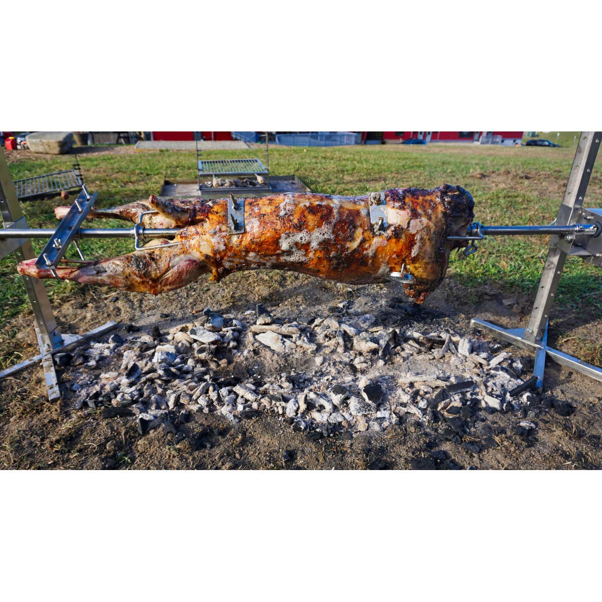 SPITJACK whole-animal roast on rotisserie with shackles for stable cooking