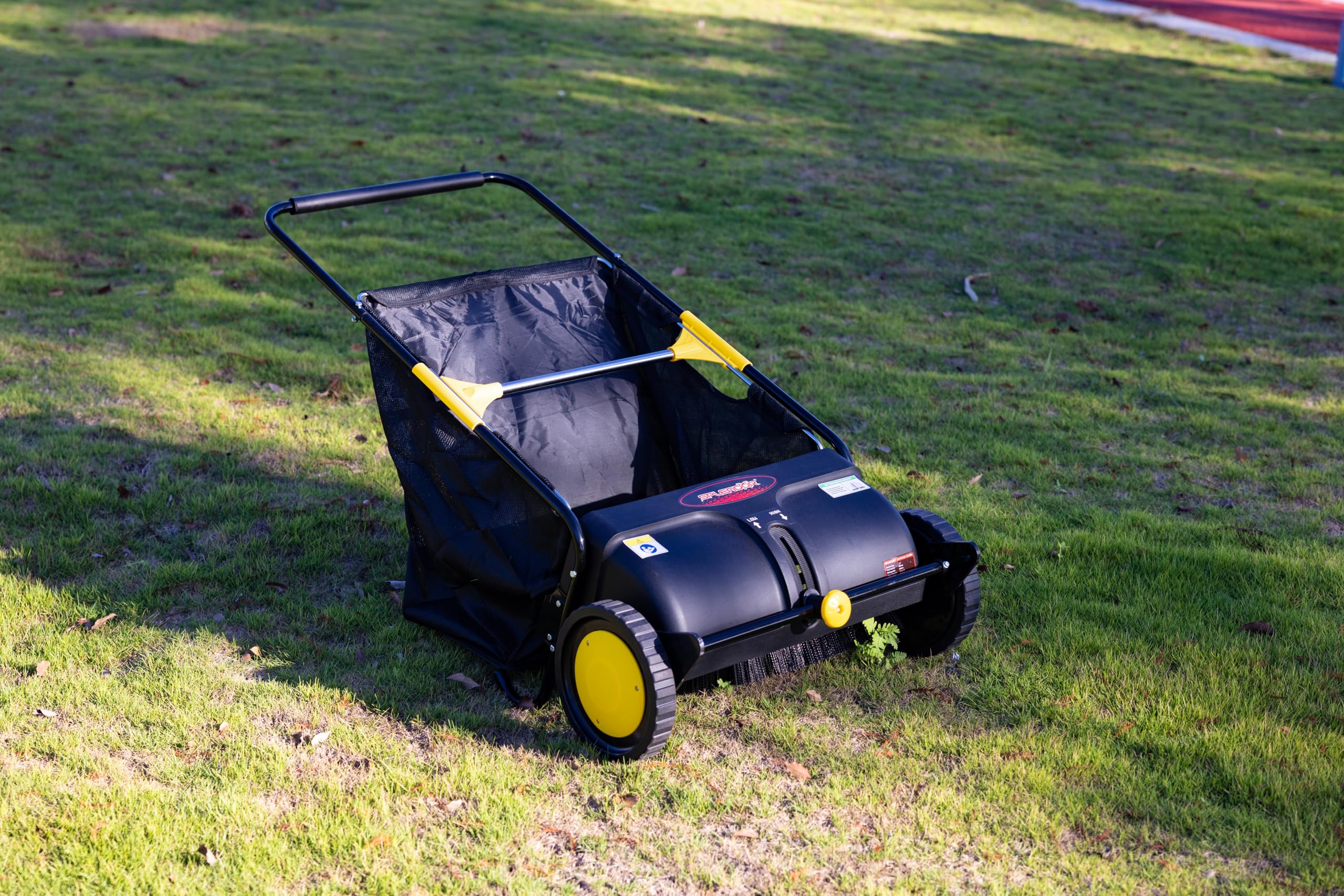 SPLENDOR in use sweeping a lawn showing fast cleanup benefit