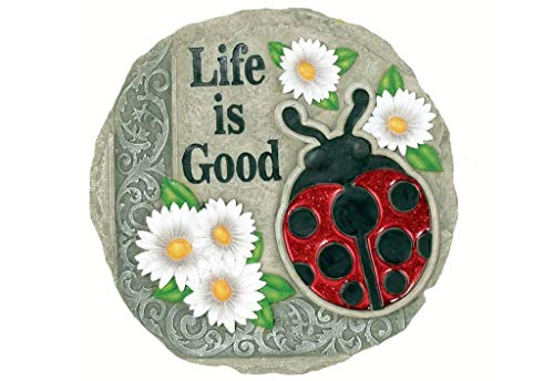 Spoontiques stepping stone placed in a flower bed adding color and pathway accent