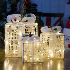 SPRKLINLIN front view of three lit gift boxes, creates warm festive ambiance