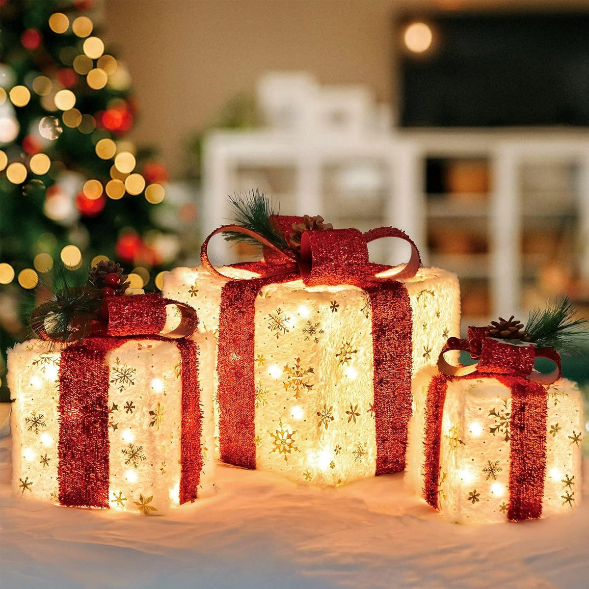 SPRKLINLIN front view of three gold snowflake lighted boxes showing festive glow and balance