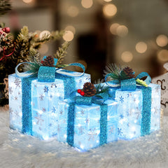 SPRKLINLIN front view of three blue snowflake gift boxes showing festive glow