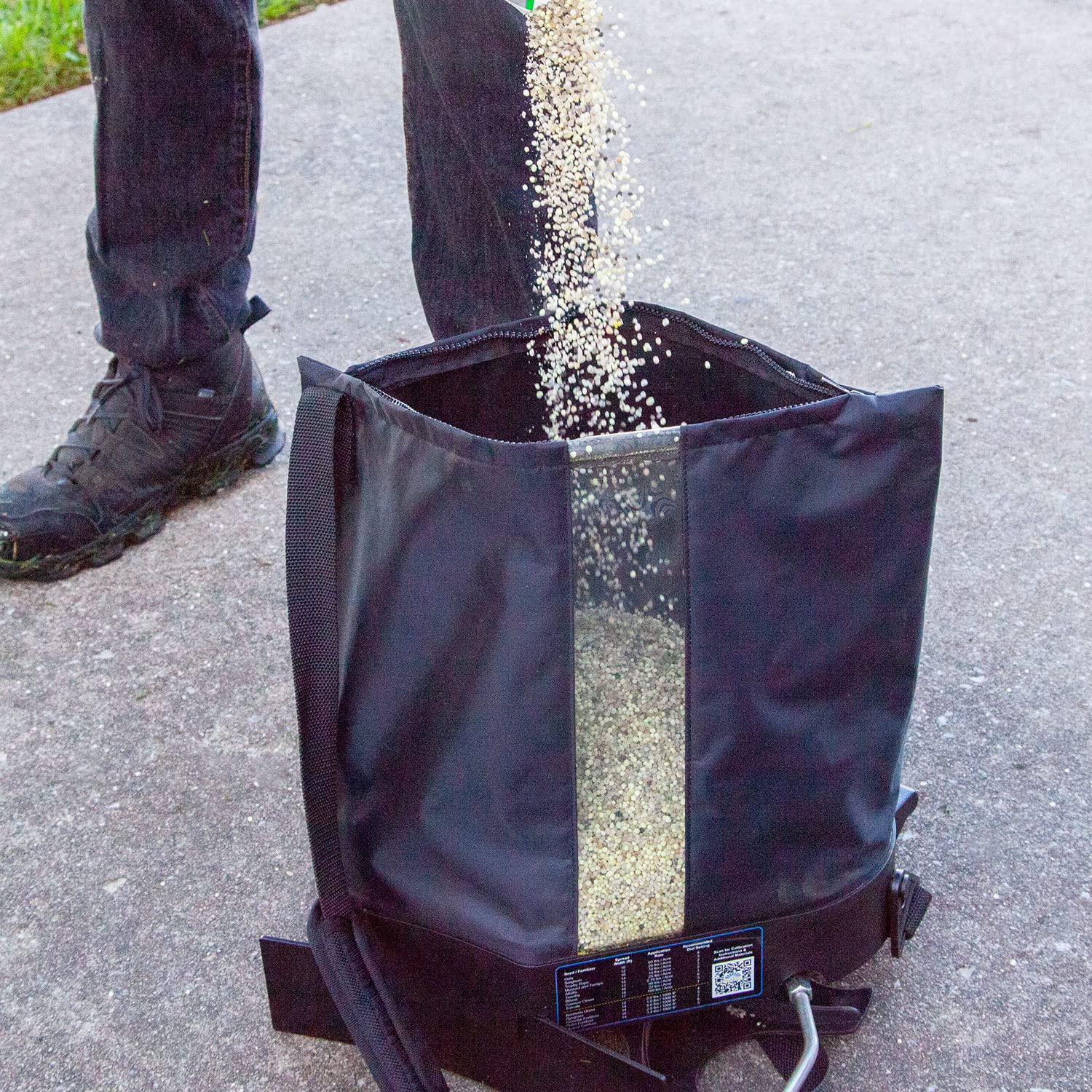 Spyker spreader next to shoe for scale to show compact size and easy maneuverability