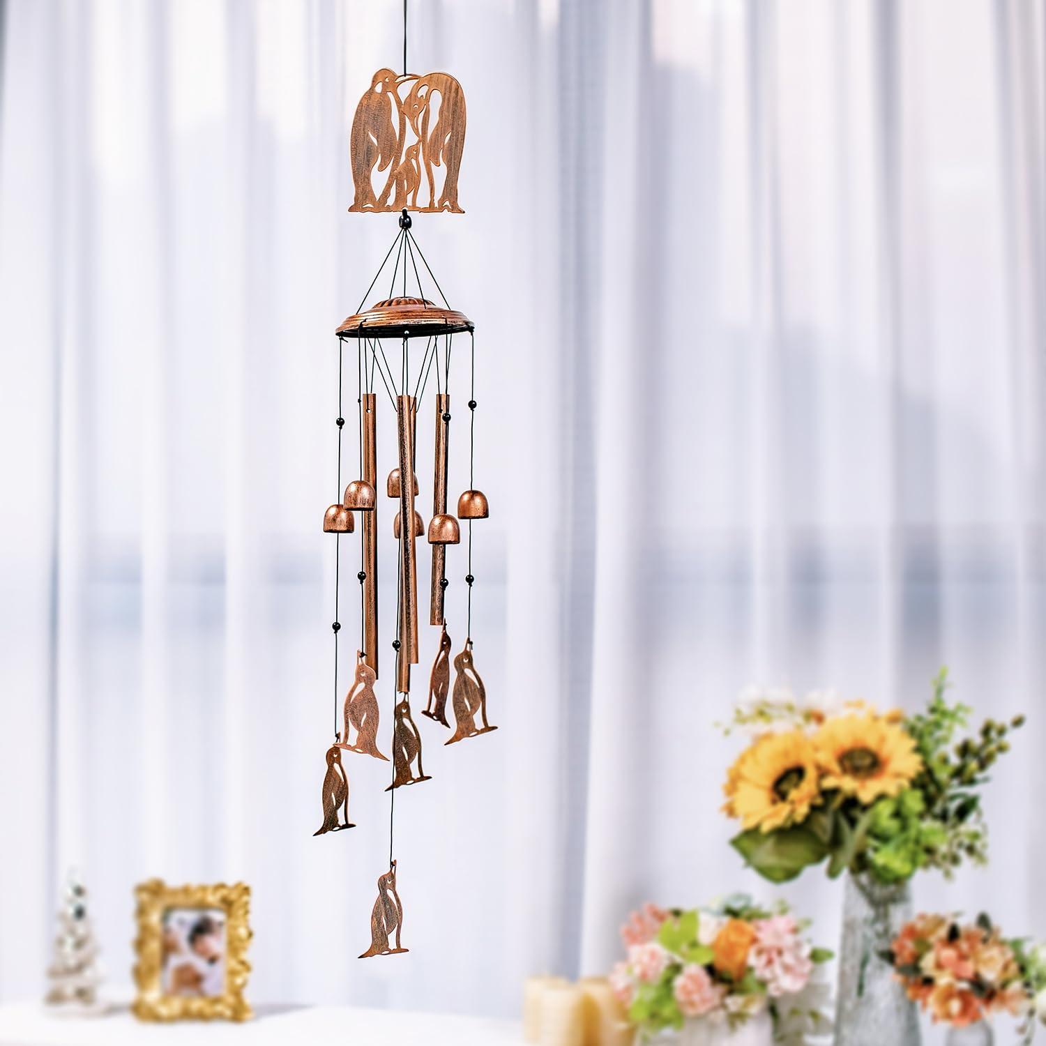 SRDJXY penguin chime in a garden setting adding whimsical decor and gentle sound