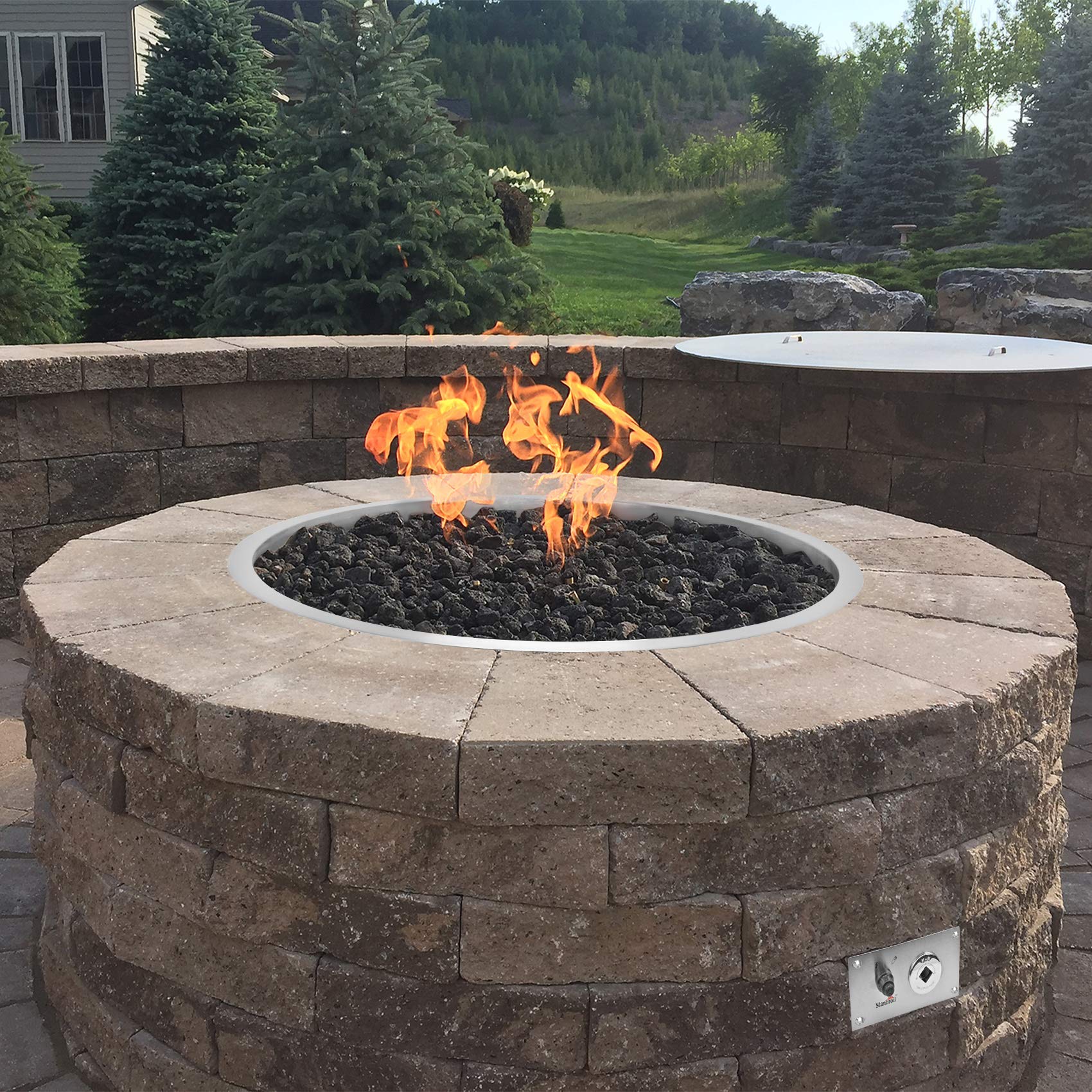 Stanbroil ignition kit installed in a backyard fire pit for quick starts