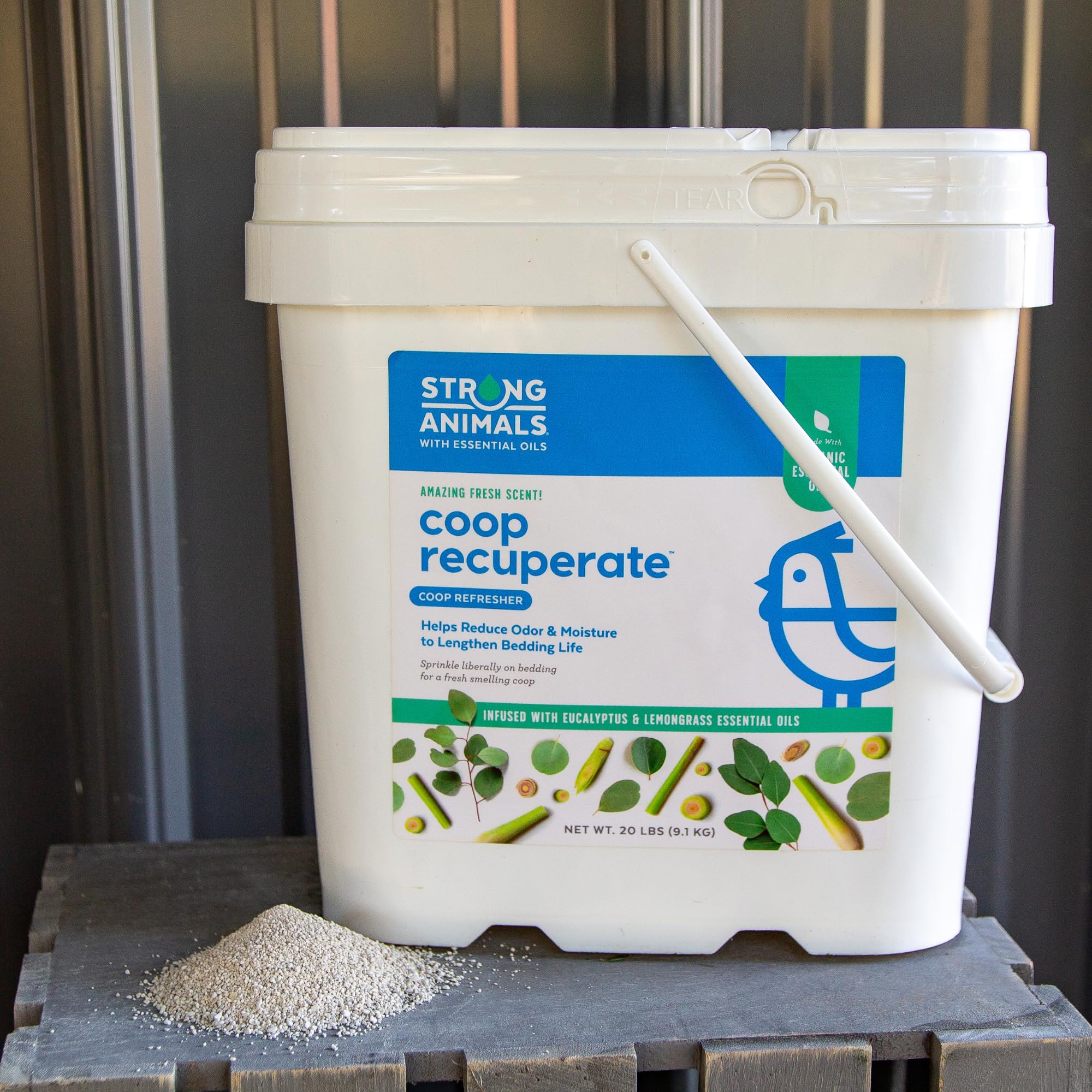 Strong Animals pail beside hand to show 20 lb scale and easy use