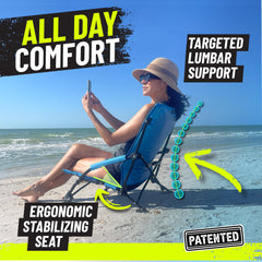 STRONGBACK chair on sandy beach illustrating extra-wide feet preventing sinking