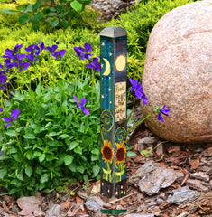 Studio M Art Pole in garden setting adding color and focal interest