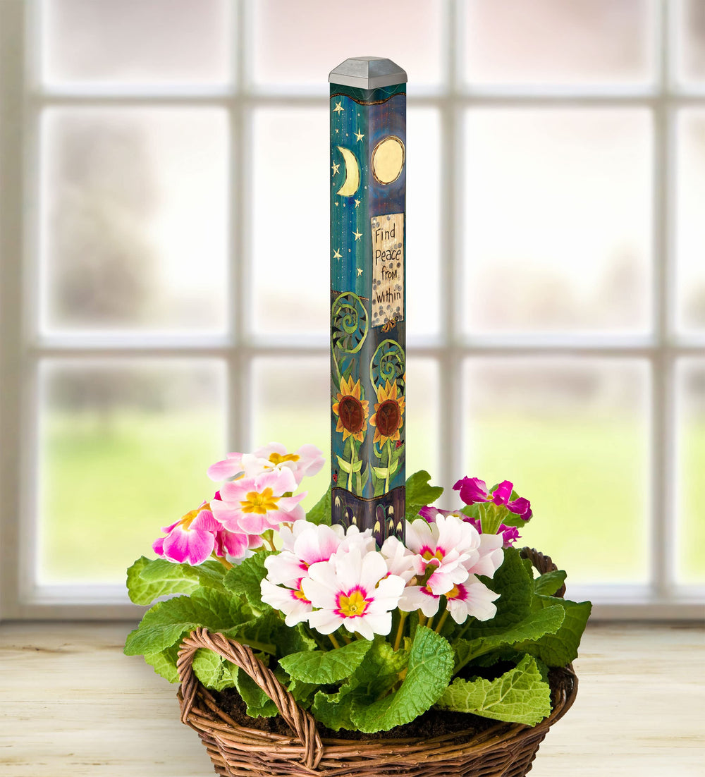 Studio M Art Pole next to hand for scale showing compact 16-inch size
