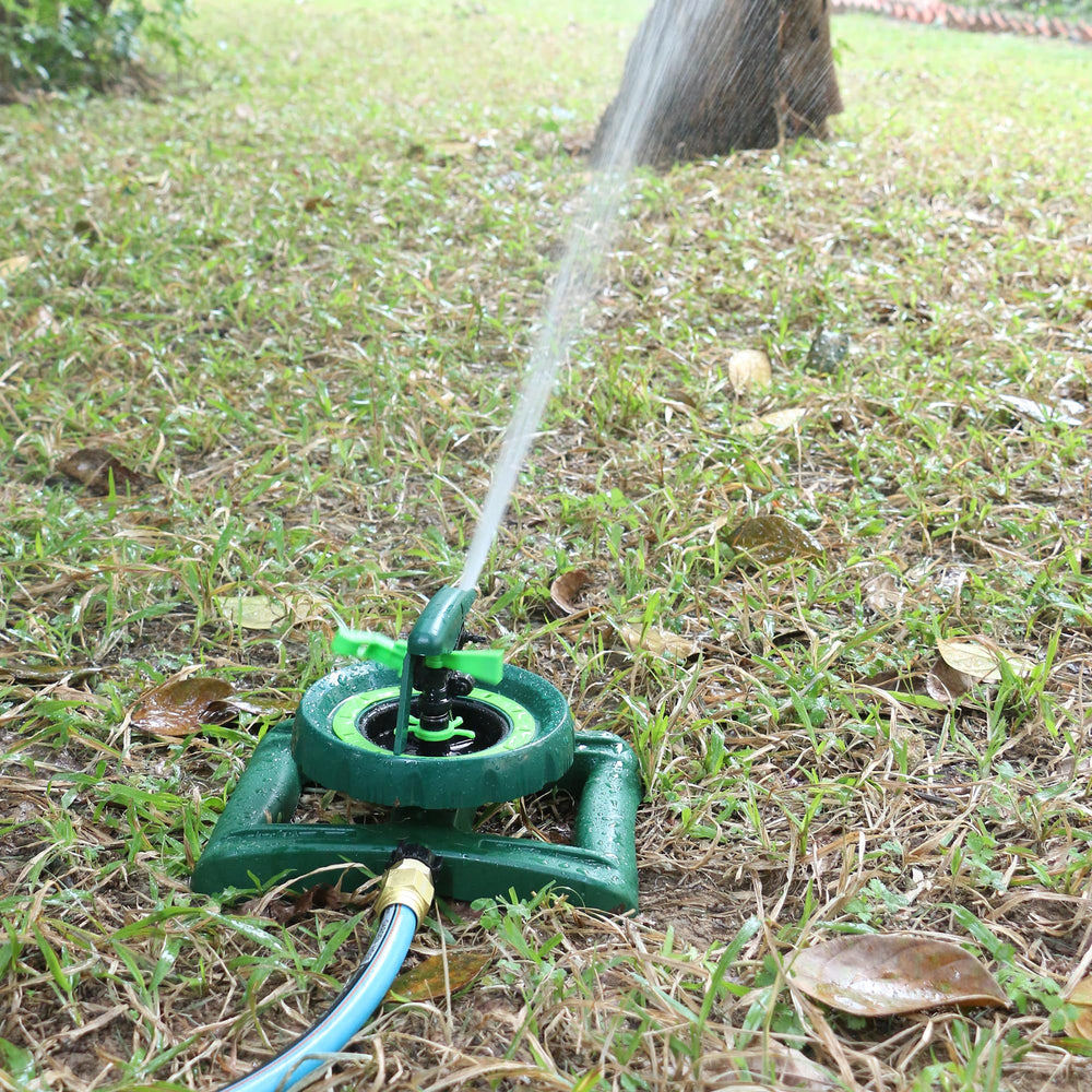 STYDDI sprinkler beside shoe for scale showing coverage reach