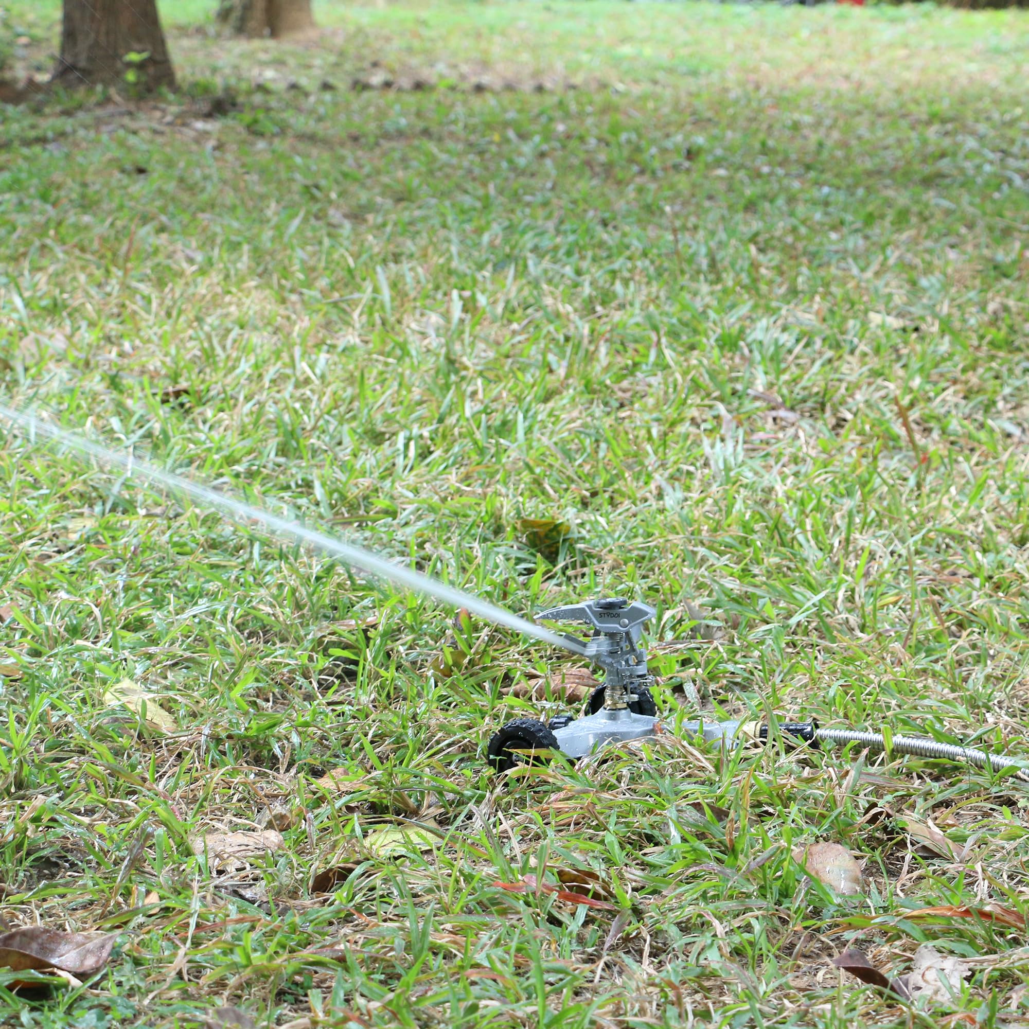 STYDDI sprinkler installed on lawn demonstrating even watering coverage benefit