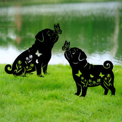 Subvise pug stakes placed in flowerbed adding personality and focal interest to plants