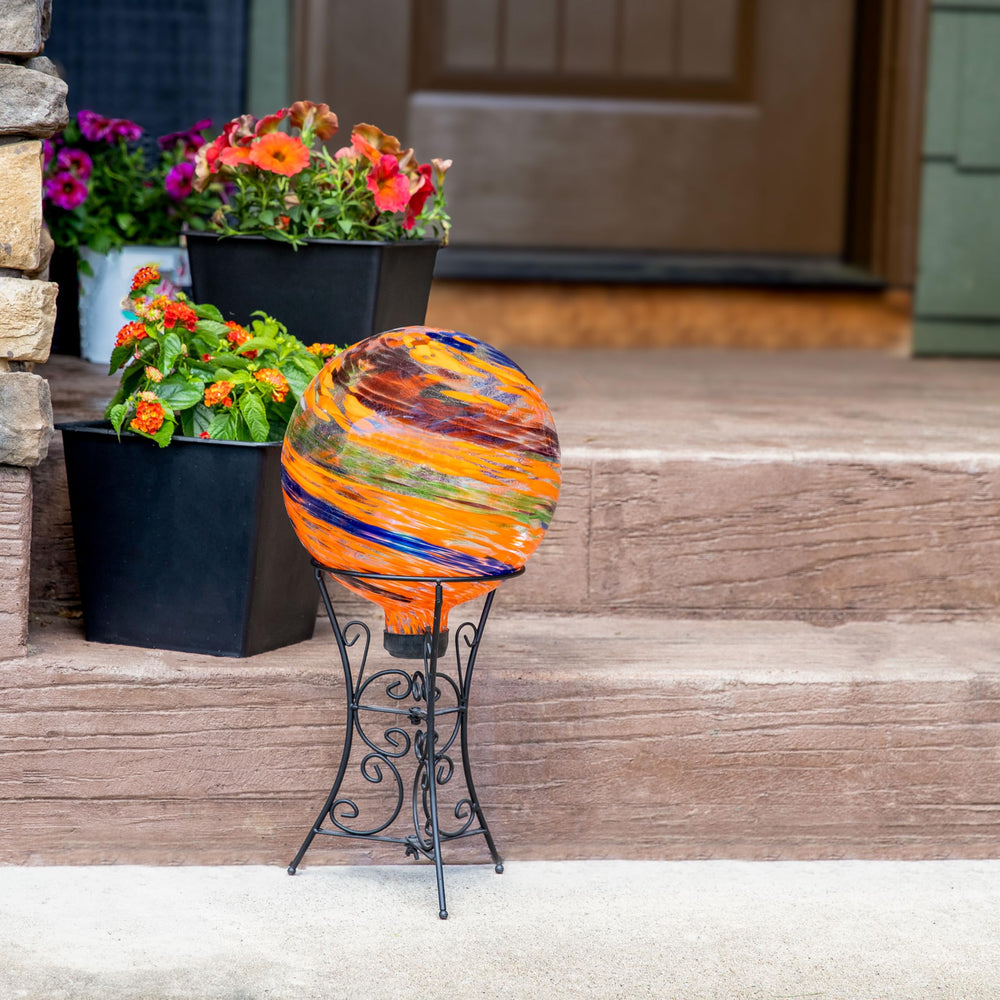 Sunnydaze globe held in hand showing 10-inch scale for easy placement and transport