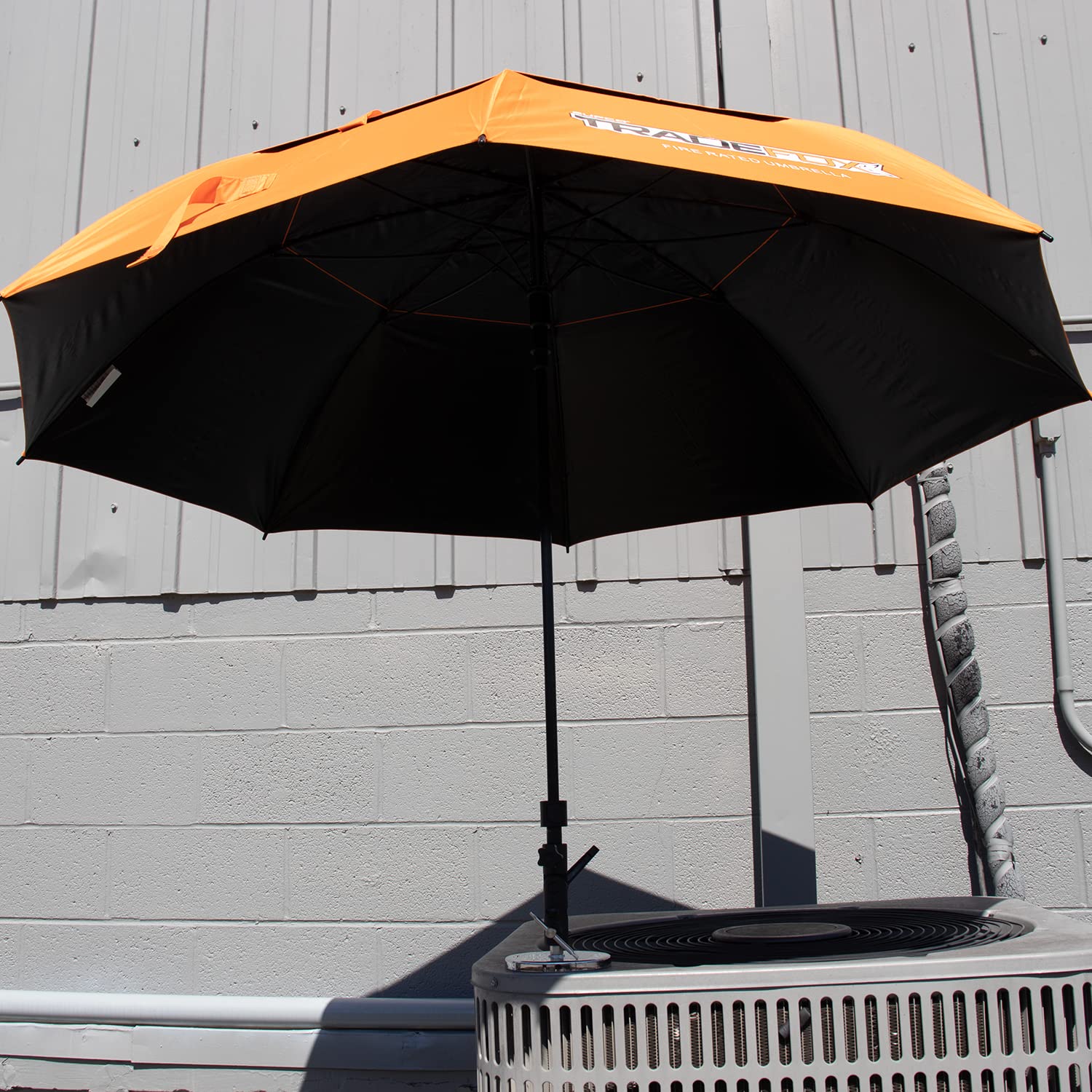 Supplying Demand umbrella held by hand demonstrating 60-inch coverage scale