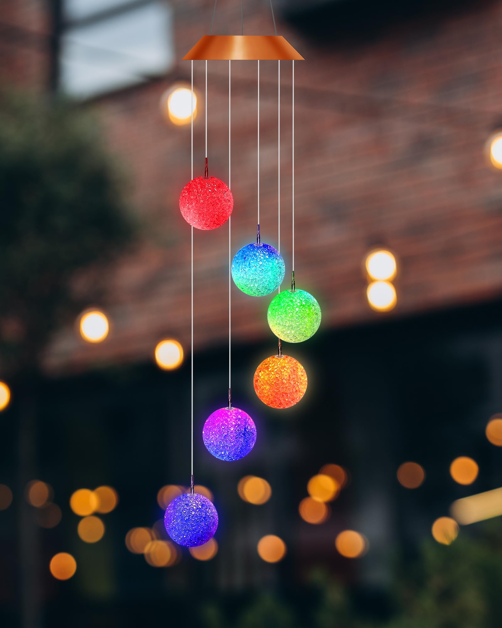 Suzile wind chime in garden at night creating colorful ambiance