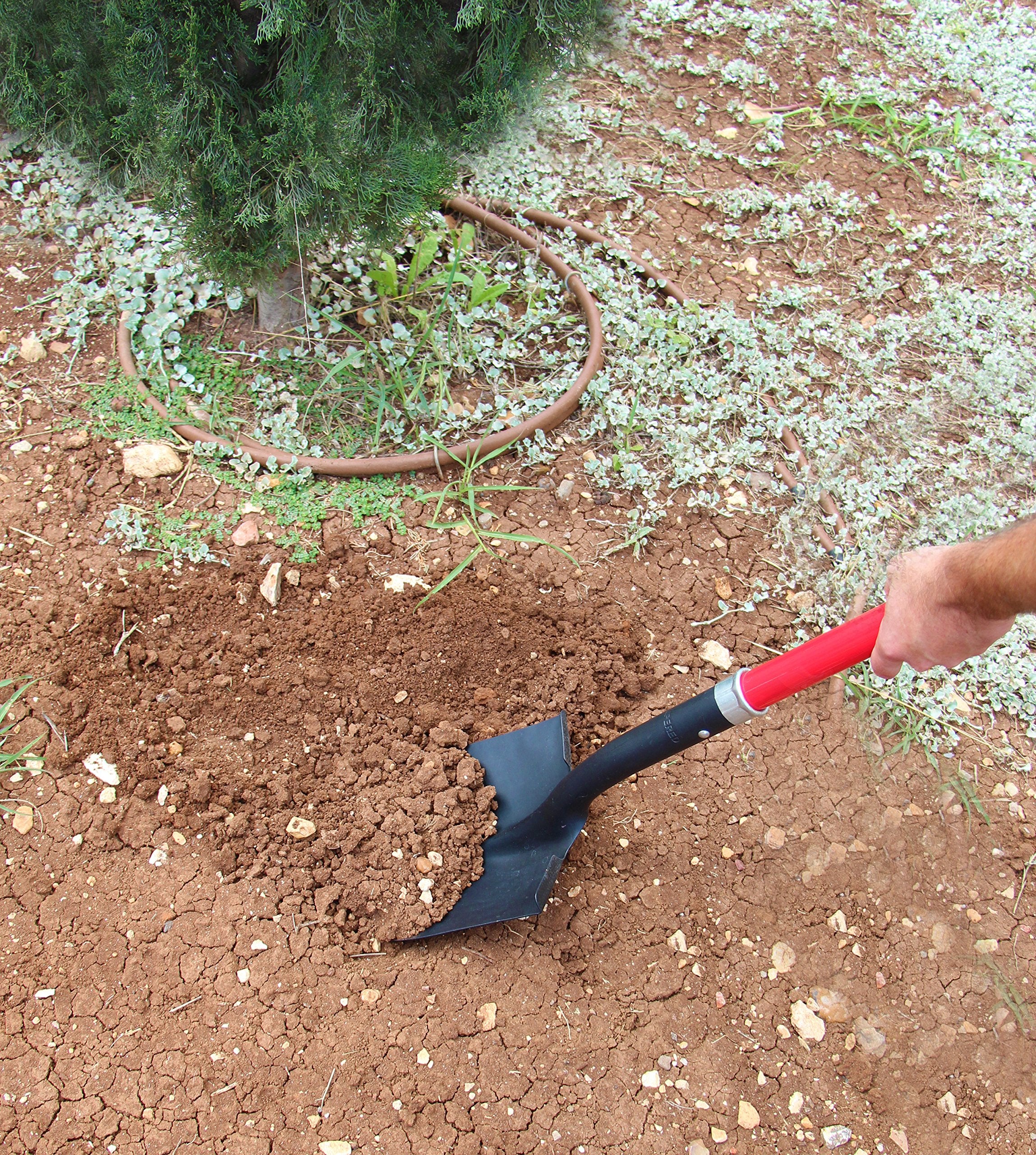 TABOR TOOLS shovel in use digging soil to show efficient scooping and root cutting