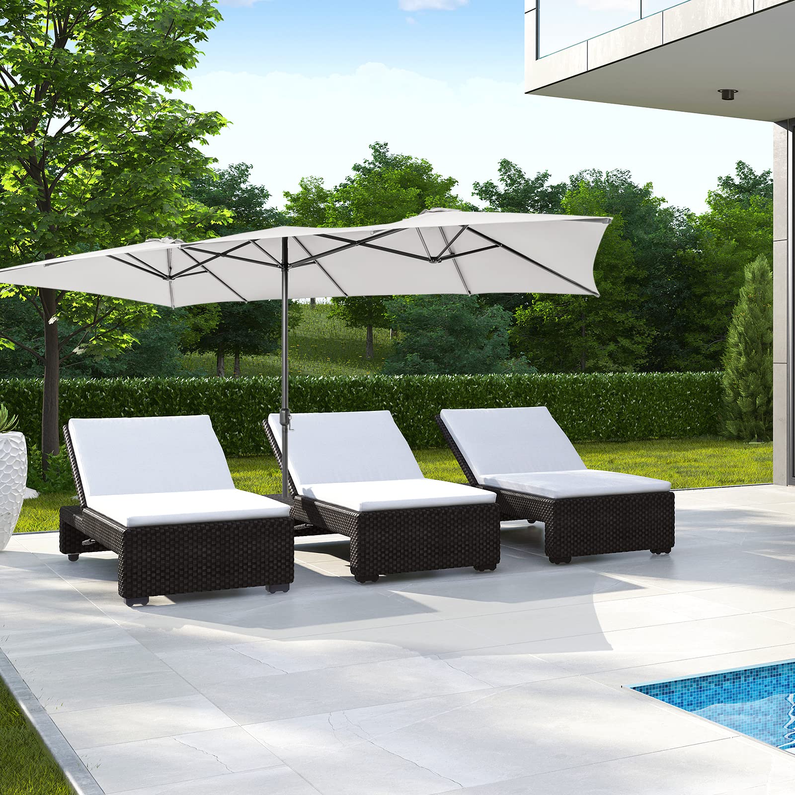 Tangkula umbrella next to a chair showing scale and generous coverage