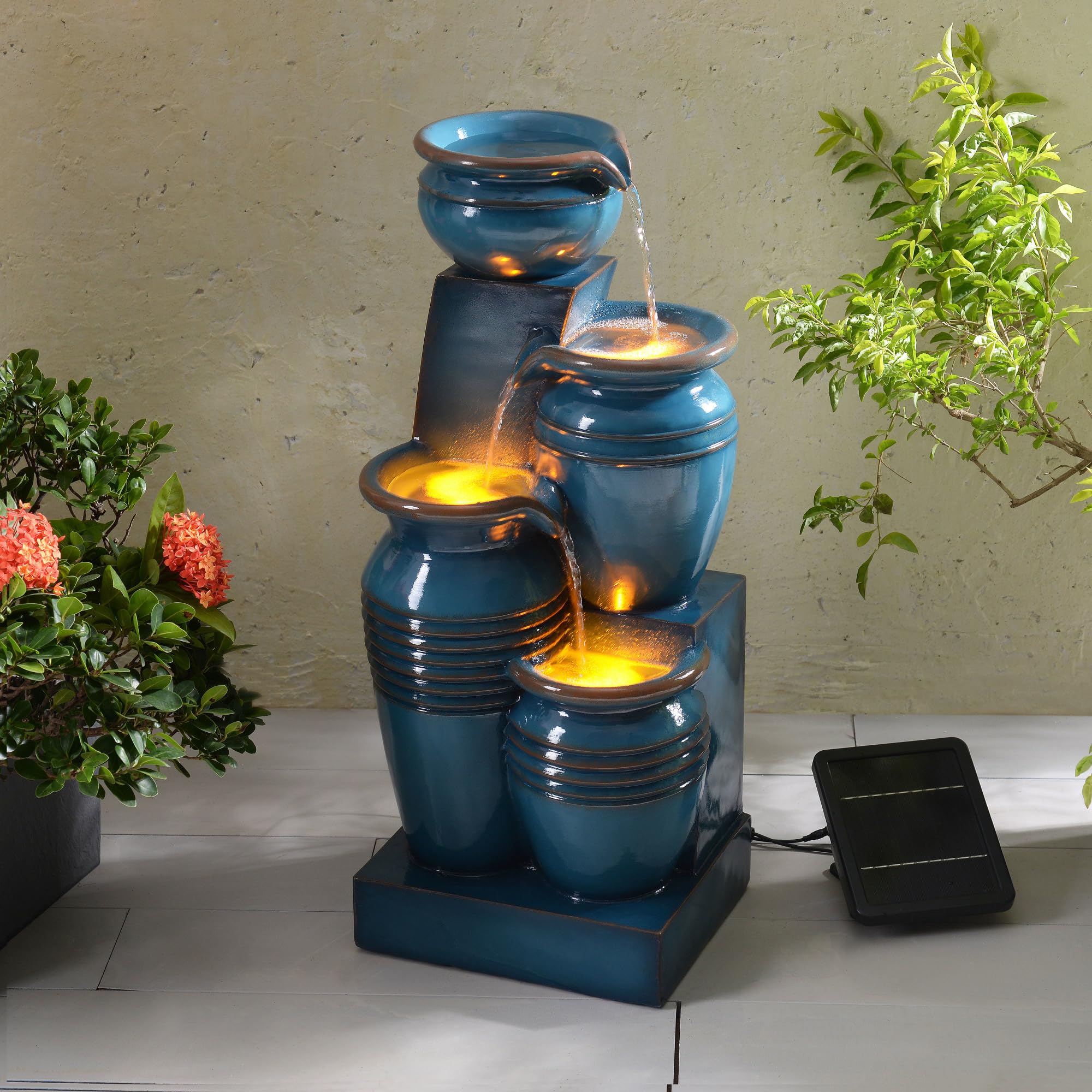 Teamson Home fountain in a patio scene showing how it enhances outdoor living benefit