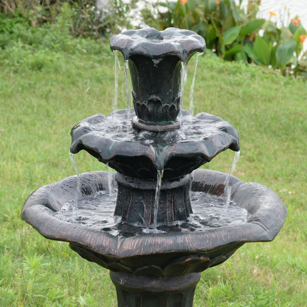 Teamson Home fountain at dusk casting reflective water highlights