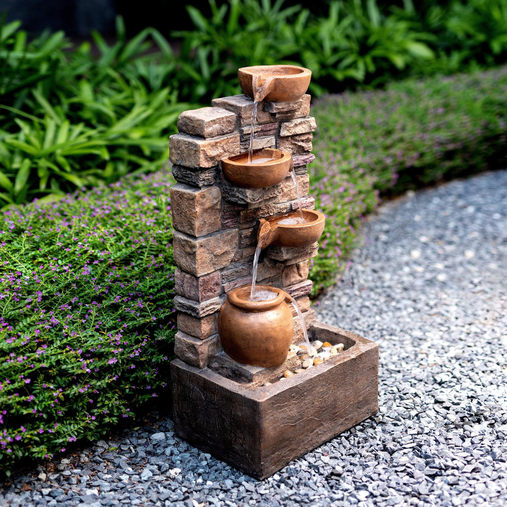 Teamson Home fountain next to outdoor chair to demonstrate scale and easy placement