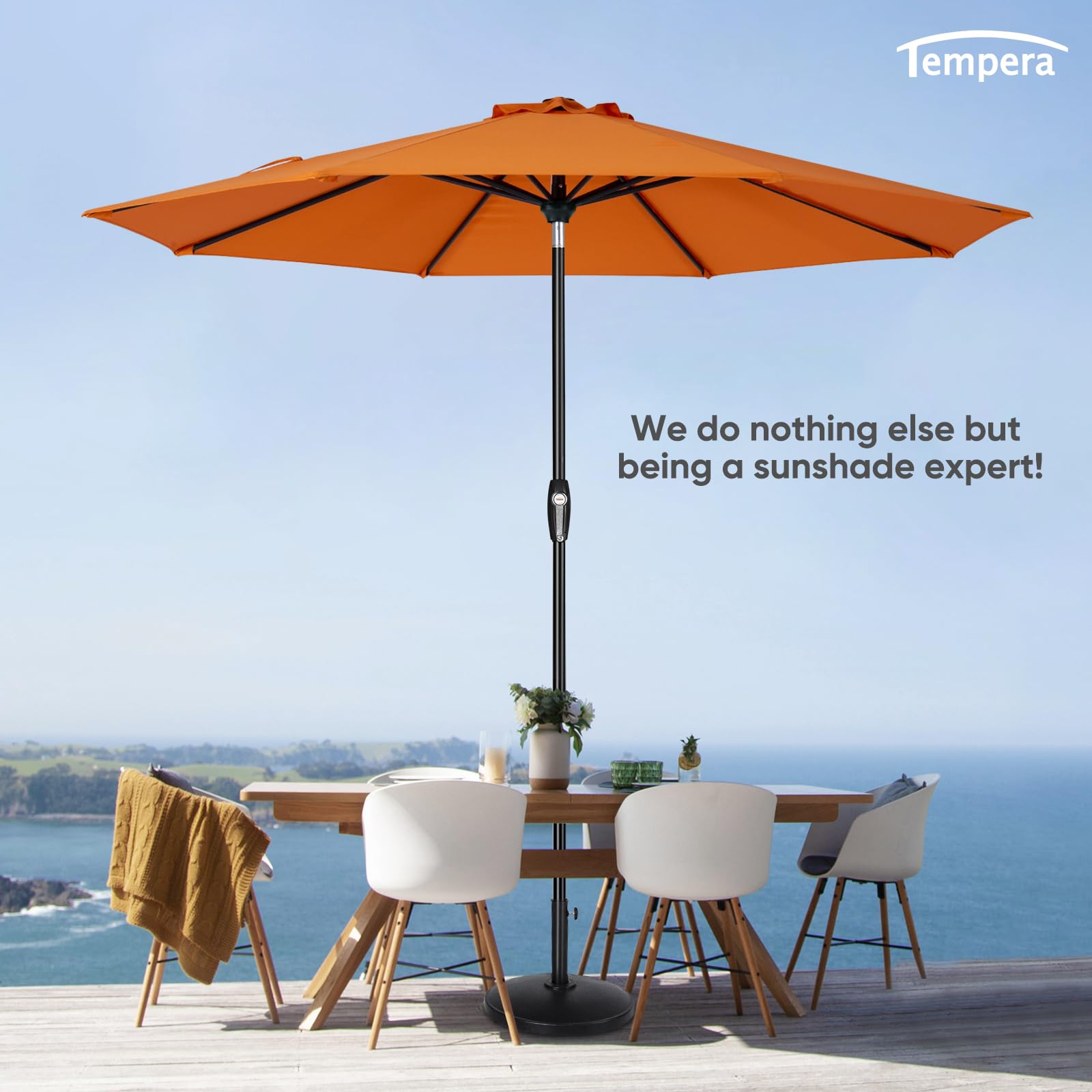 Tempera umbrella next to table illustrating 9ft coverage for four to six chairs