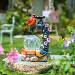 TERESA'S COLLECTIONS cardinal placed in a plant pot offering colorful focal point and easy placement