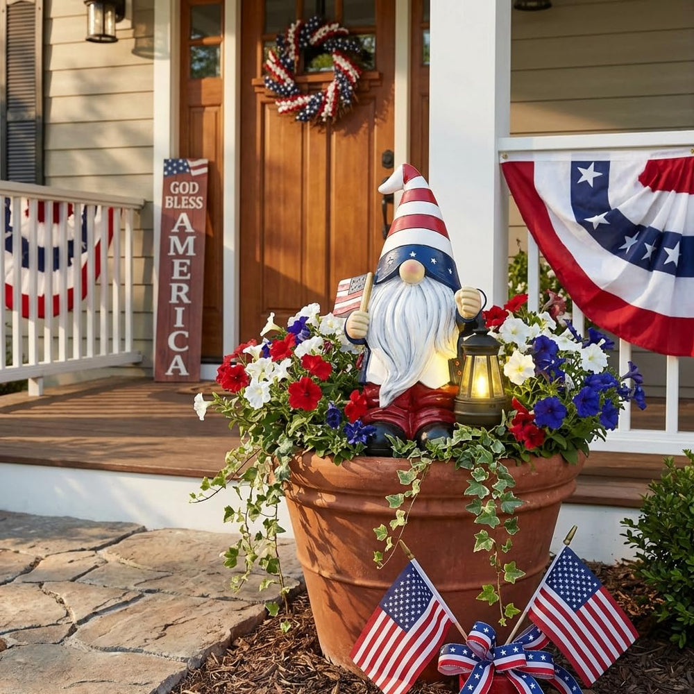 TERESA'S COLLECTIONS gnome placed in garden adding charming patriotic accent among plants