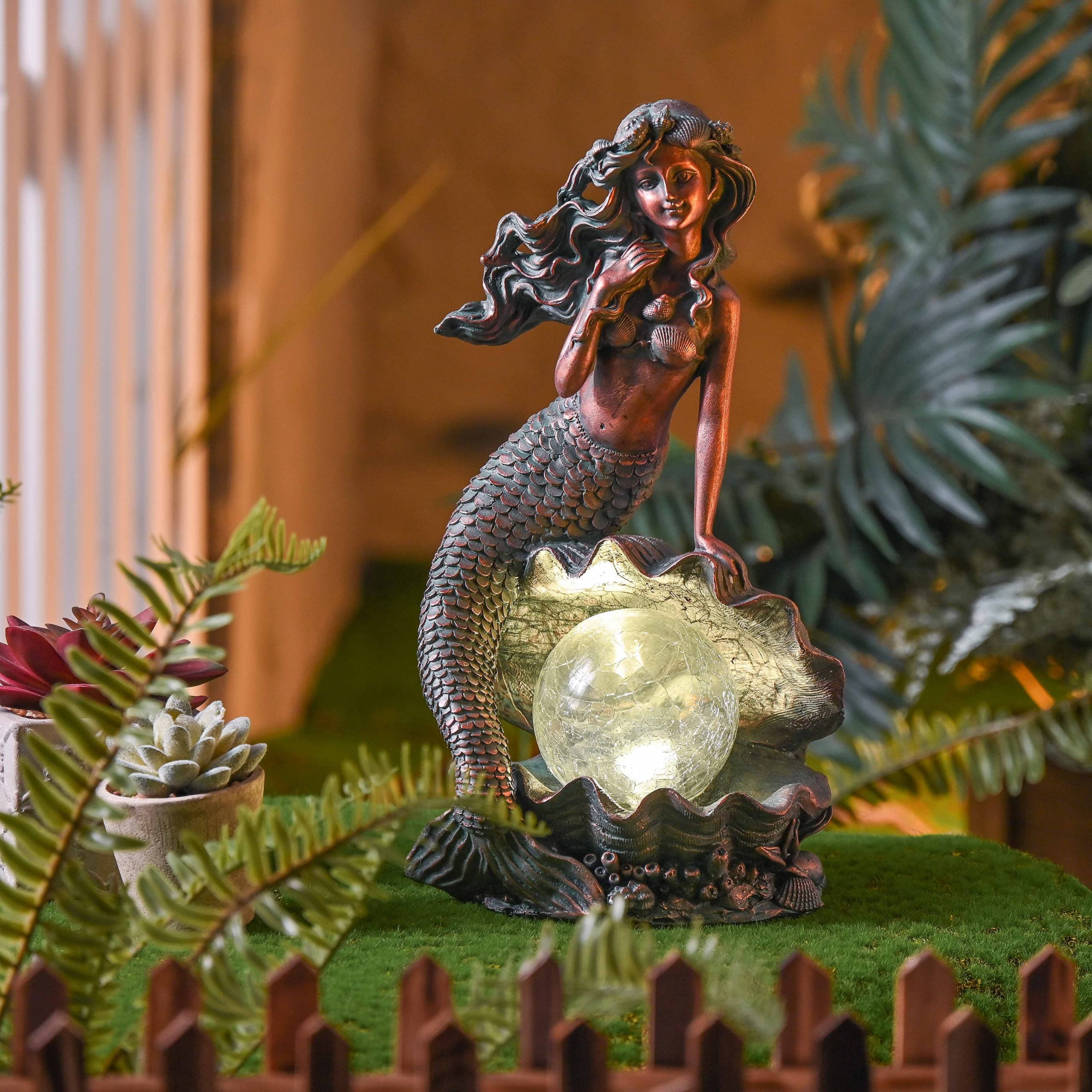 TERESA'S COLLECTIONS mermaid placed in a planter adding nautical accent