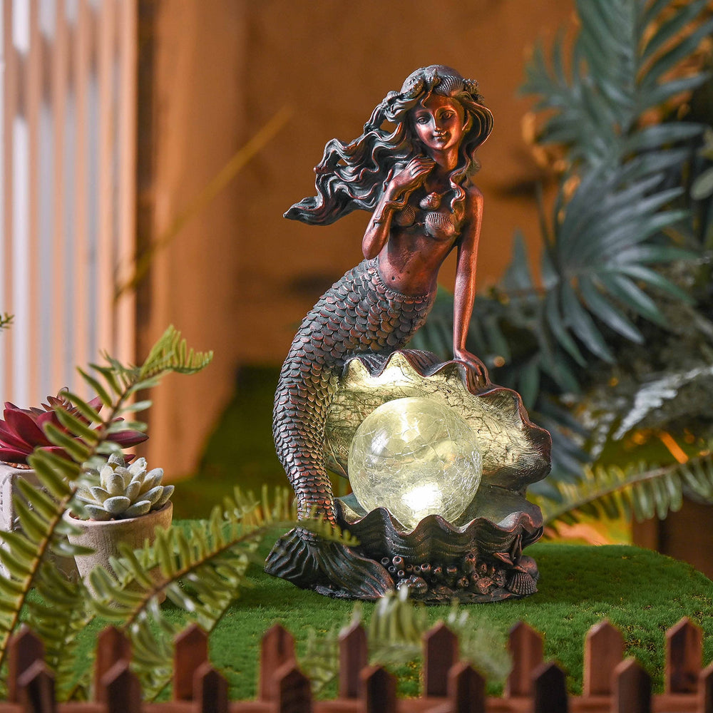 TERESA'S COLLECTIONS mermaid placed in a planter adding nautical accent