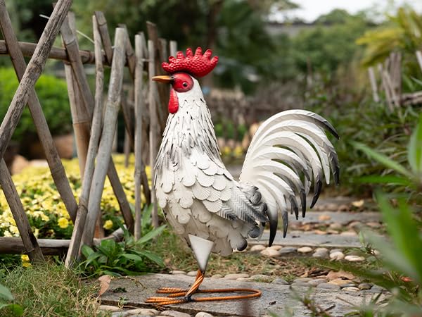 TERESA'S COLLECTIONS rooster placed in a flowerbed showing weatherproof outdoor use