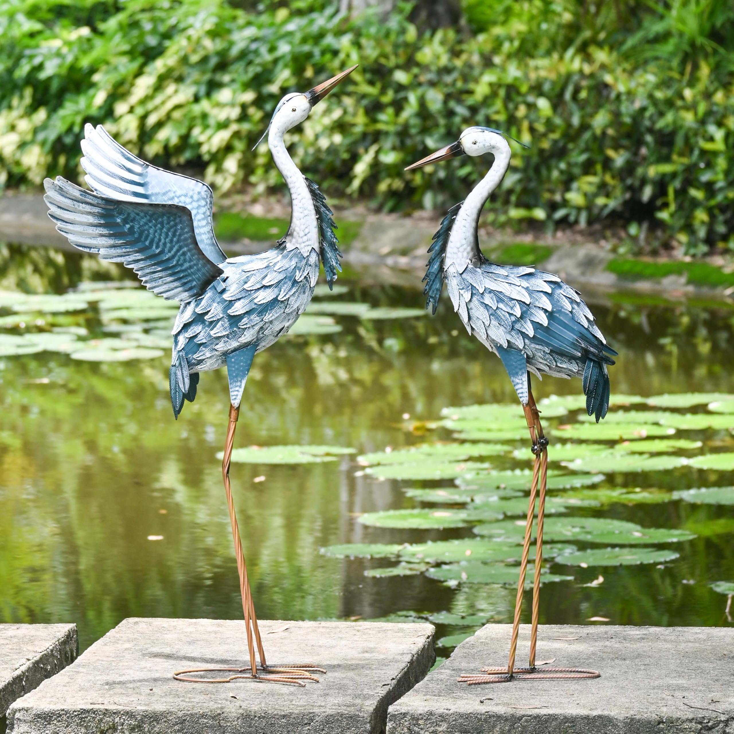TERESA'S COLLECTIONS staked heron in garden bed provides stable focal point