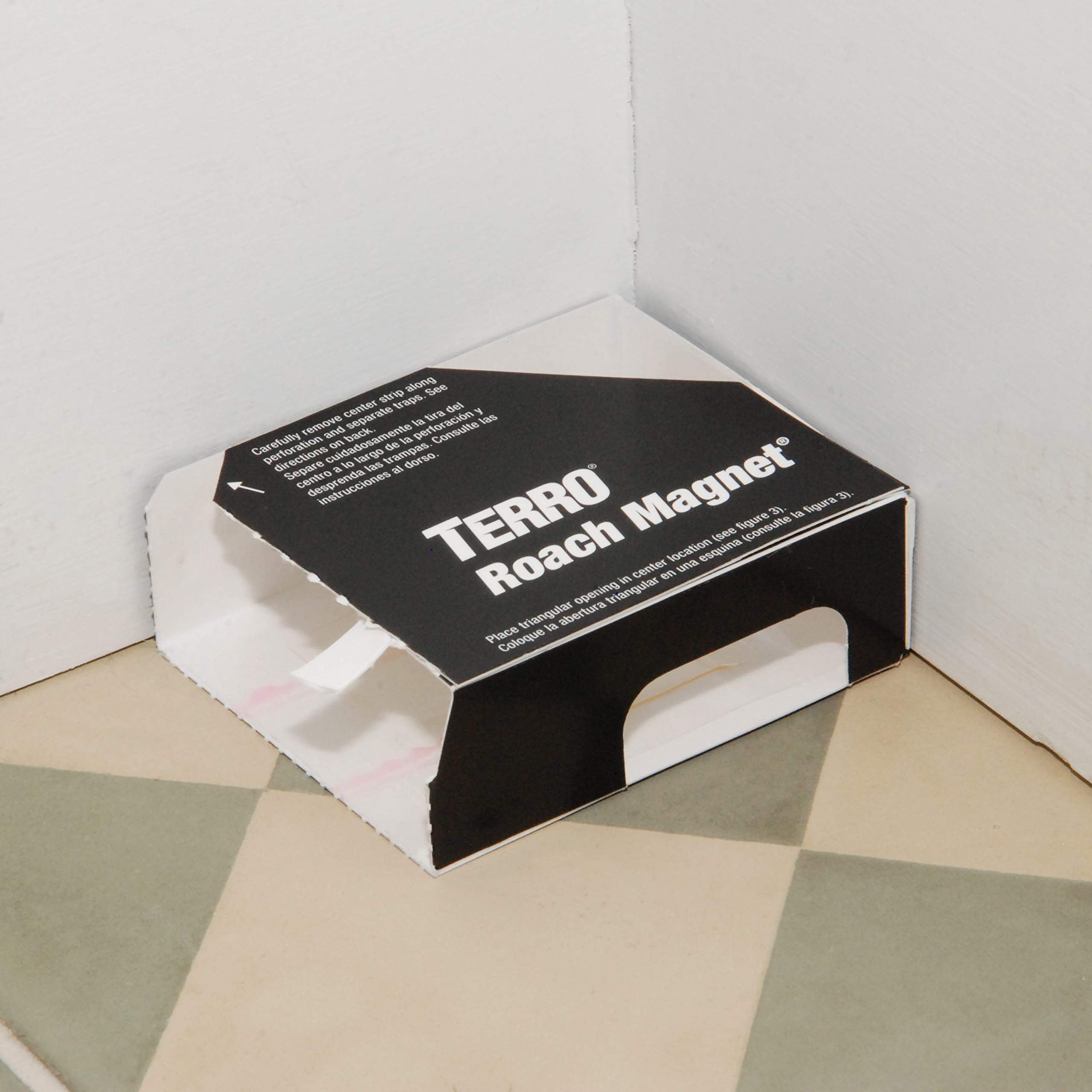 Terro roach magnet placed under refrigerator demonstrating discreet placement benefits