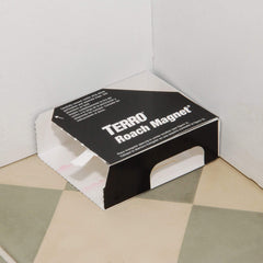 Terro roach magnet placed under refrigerator demonstrating discreet placement benefits